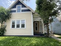 Charming home featuring a quaint front porch and well-maintained yard, creating a welcoming curb appeal at 1153 Villa Ave, Indianapolis, IN 46203