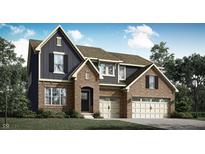 A charming two-story home with a brick and siding exterior, complemented by a well-manicured lawn at 11557 Aubrey Ln, Fishers, IN 46040