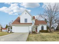 Charming two-story home showcasing a manicured lawn, two-car garage, and a classic architectural design at 1542 Waterford Dr, Zionsville, IN 46077