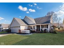 Charming single-story home with manicured lawn, attached garage and inviting front porch at 18007 Sun Ridge Cir, Noblesville, IN 46062