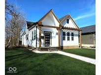 Charming two-story home featuring a well-manicured lawn and modern design elements at 1818 N Cornell Ave, Indianapolis, IN 46202