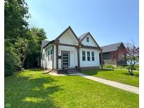 Charming home with craftsman-style architecture, lush lawn, and inviting curb appeal at 1818 N Cornell Ave, Indianapolis, IN 46202