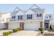 Charming two-story townhouse with attached two-car garage and well-maintained landscaping at 1848 Misty Lake Dr, Indianapolis, IN 46260