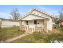 Cozy single Gathering home featuring a quaint front porch and neutral exterior, providing comfort and charm at 211 Jones St, Columbus, IN 47201