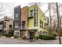 Stunning contemporary home with a unique facade, stone accents, and a modern color palette at 2417 E 80Th E St, Indianapolis, IN 46240