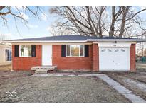 Charming brick ranch-style house with a well-maintained front yard and attached garage at 3130 Elizabeth St, Indianapolis, IN 46234