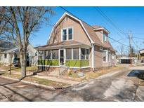 Charming two-story home with a screened front porch and well-maintained landscaping at 320 15Th St, Columbus, IN 47201