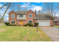 Charming two-story brick home featuring an attached two-car garage and a well-manicured front yard at 332 Wellington Pkwy, Noblesville, IN 46060