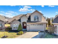 Charming two-story home featuring a brick and siding exterior with an attached two-car garage and well-manicured landscaping at 4139 Bella Ct, Indianapolis, IN 46237