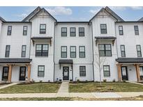 Charming townhome exterior with white siding, black trim, and a well-manicured lawn at 4321 Barrel Ln, Westfield, IN 46062