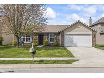 Charming single-Gathering home with brick and siding, a well-manicured lawn, and an attached two-car garage at 4732 Ashfield Dr, Westfield, IN 46062