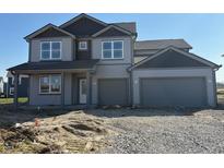 Two story home featuring gray siding, a two car garage, and dark gray accents at 5558 Tart Blvd, Indianapolis, IN 46239