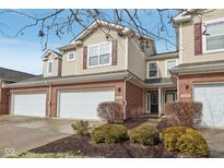Attractive townhome featuring a brick facade, attached two-car garage, and landscaping at 5682 Castor Way, Noblesville, IN 46062