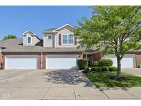 Charming two-story townhouse with a brick facade, manicured lawn, and attached one-car garage at 5682 Castor Way, Noblesville, IN 46062