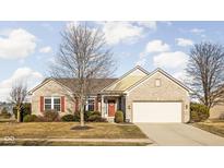 Charming brick home featuring a two-car garage and a welcoming front entrance with red shutters at 649 Hummingbird Dr, Brownsburg, IN 46112