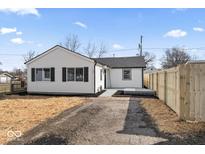 Charming single-story home featuring a new fence, modern windows, and a freshly sealed driveway at 707 S Biltmore Ave, Indianapolis, IN 46241