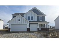 Two-story home featuring a two-car garage and white and dark blue siding at 7231 Estes Dr, Indianapolis, IN 46239