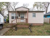 Charming single-story home featuring a covered porch, light siding, and a well-maintained front yard at 1142 Sharon Ave, Indianapolis, IN 46222