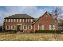 Charming two-story red brick home featuring a well-maintained lawn and inviting curb appeal at 14080 Old Mill Ct, Carmel, IN 46032