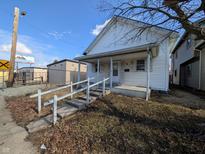 Charming exterior of a home featuring a quaint porch and classic design, perfect for a cozy lifestyle at 1610 Central Ave, Anderson, IN 46016