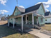 Vintage exterior showcases a porch with awning, and a traditional design, needs TLC at 1628 Sherman St, Anderson, IN 46016