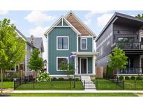 Charming two-story home boasts lush lawn, landscaping, and a welcoming front entrance with a well-manicured lawn at 2117 Broadway St, Indianapolis, IN 46202