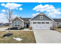 Charming single-story home with stone accents, a two-car garage, and a well-manicured lawn at 2691 Sand Hollow Dr, Lebanon, IN 46052