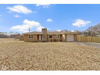 Charming single-story brick home with a well-maintained lawn and attached one car garage at 305 Bixler Rd, Indianapolis, IN 46227