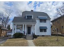 Charming home featuring a covered front porch and classic architectural details at 341 N Bolton Ave, Indianapolis, IN 46219