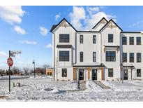 Beautiful new construction townhome featuring a striking white facade and modern design elements at 4140 Douro Trl, Westfield, IN 46062