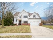 Charming two-story home boasts classic architecture, attached two-car garage, and inviting curb appeal at 4365 Weather Stone Xing, Zionsville, IN 46077