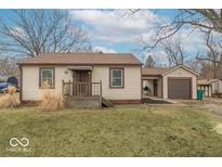Charming single-story home with neutral siding, covered front porch, and detached garage at 4836 W 71St St, Indianapolis, IN 46268