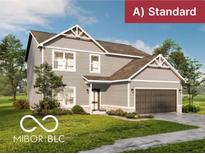 Charming two-story home features a covered porch, a two-car garage, and professionally landscaped yard at 7284 Fowler Dr, Whitestown, IN 46075