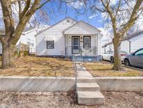 Charming single-story home with white siding and a cozy front porch at 819 Manhattan Ave, Indianapolis, IN 46241