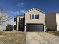 Charming two-story home with a well-kept lawn and a two-car garage, perfect for Gathering living at 8360 S Evening Dr, Pendleton, IN 46064