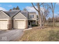 Charming townhome featuring an attached garage and well-maintained front yard, creating a welcoming curb appeal at 9571 Aberdare Dr, Indianapolis, IN 46250