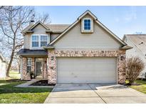 Charming two-story home featuring brick accents, attached two-car garage, and well-maintained landscaping at 9723 Innisbrook Blvd, Carmel, IN 46032