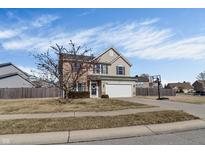 Charming two-story home featuring a two-car garage, a welcoming front door, and a well-maintained lawn at 10326 Haag Dr, Brownsburg, IN 46112