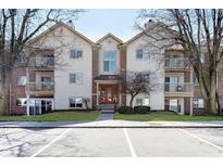 Exterior view of a three story condo with manicured lawn and ample parking in front at 1057 Timber Creek Dr # 12, Carmel, IN 46032
