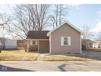 Charming single-story home with neutral siding, covered porch, and bench, offering a cozy and inviting curb appeal at 108 N Maple St, Pittsboro, IN 46167