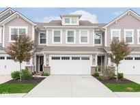 Charming townhome featuring a two-car garage, traditional design, and manicured landscaping at 1274 Newton St, Avon, IN 46123