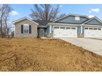 New construction home with blue siding, stone accents, and a two-car garage on a sunny day at 140 Mission Terrace Dr, Whiteland, IN 46184
