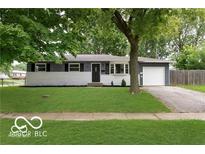 Charming single-story home with a well-maintained lawn and mature trees providing shade at 1807 Dayton Ave, Indianapolis, IN 46203