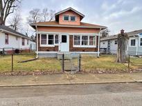 Charming bungalow-style home featuring brick and vinyl siding, a small yard, and inviting curb appeal at 1826 Mansfield St, Indianapolis, IN 46202