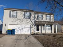 Two-story home with a two-car garage, gray shutters, and a well-maintained lawn and landscaping at 18924 Planer Dr, Noblesville, IN 46062