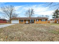Charming single-story brick home featuring an attached garage and welcoming front porch at 3515 S Meadow Dr, Indianapolis, IN 46239