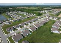 Expansive aerial view of a suburban neighborhood, showcasing well-maintained lawns and the Bear Slide Golf Club in the distance at 50 Hovden Dr, Cicero, IN 46034