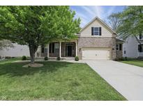 Attractive two-story house with a well-manicured lawn and a combination of brick and siding, plus an attached garage at 6126 Golden Eagle Dr, Zionsville, IN 46077