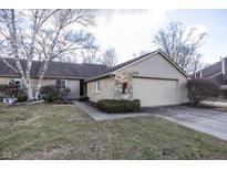 Charming single-story home with stone and siding, features an attached garage and a well-maintained front yard at 615 Conner Creek Dr, Fishers, IN 46038