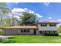 Charming two-story home featuring a well-maintained lawn and a brick and vinyl exterior at 6340 Shanghai Rd, Indianapolis, IN 46278